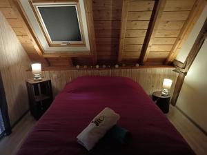 a small room with a bed with a tv at Mielogite in La Croix-en-Touraine