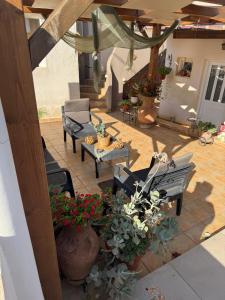 an outdoor patio with chairs and tables and plants at Marathi Apartments in Marathi +62 photos