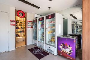 a store with an open refrigerator in a room at Vista do 17º andar e pertinho do metrô! in Sao Paulo