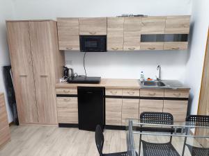 a kitchen with a counter and a table and chairs at Olszynowe Wzgórze in Sianozety