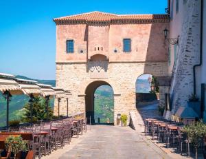a building with tables and chairs on a street at Prospect in Motovun
