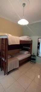 two bunk beds in a room with a light at Maria's House in Karpathos Town +13 photos