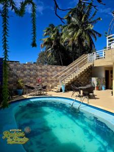 a swimming pool in front of a house at Porto De Galinhas Pousada Raízes Do Porto in Porto De Galinhas