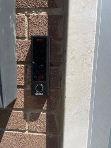 a remote control on the side of a brick wall at Appartamento Bianca in Prato +2 photos