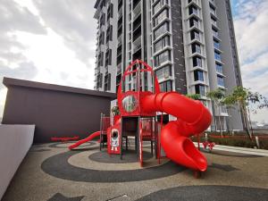 a playground in front of a tall building at Astetica5 4BR Spacious Home w Netflix WiFi in Serdang