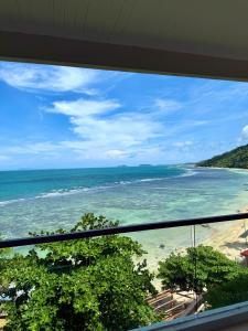 a view of the ocean from a balcony at Sunset Beach Hotel - Adults Only in Haad Rin +54 photos