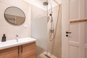 a bathroom with a sink and a mirror at Harmony House Apartment in Budapest