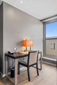 a desk with a lamp and a chair in a room at Relais de L'Empereur in Genappe