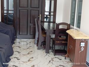 a dining room with a table and chairs and a door at Akash Premium Hotel in Nilaveli