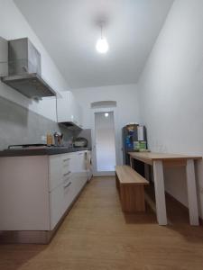 a kitchen with a counter and a table in it at Casa Rasi in Maratea +10 photos