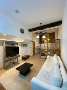 a living room with a couch and a flat screen tv at Altos 679inn in Comodoro Rivadavia