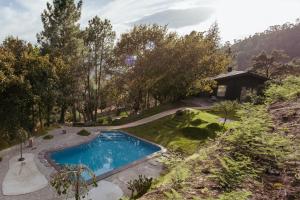 an image of a swimming pool in a garden at Quinta do Desenho - Douro Valley - Private Pool & Sauna in Paços de Gaiolo