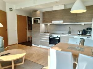 a kitchen and dining room with a table and chairs at Ruka Ski Chalets, Ski-In Ski-Out in Ruka +9 photos
