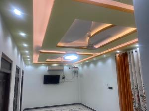 a ceiling in a hallway with a room with white walls at Akash Premium Hotel in Nilaveli
