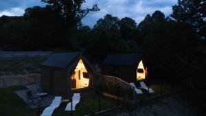 a couple of small houses with lights on them at night at Termalna Osada in Brenna