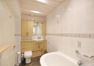 a white bathroom with a sink and a toilet at Pointgarry in North Berwick +29 photos