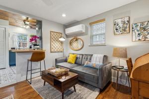 a living room with a couch and a table at The Cultural District Cottage in Fort Worth