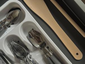 a sink with spoons and utensils in it at Pärnu Summer Studio in Pärnu