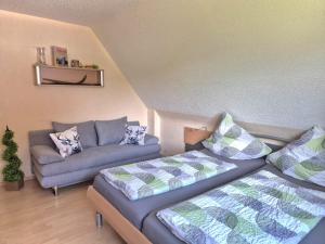 ein Wohnzimmer mit zwei Betten und einer Couch in der Unterkunft Ferienhaus Seefried in Baiersbronn
