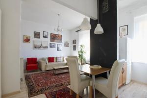 a living room with a table and chairs at Standard Apartment by Hi5 - Károly 23 in Budapest