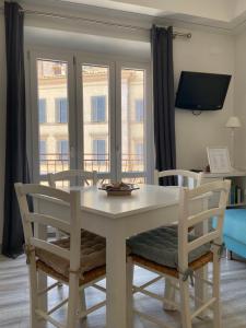 a dining room with a table and chairs and windows at Sweet Home in San Rocco in Bolsena