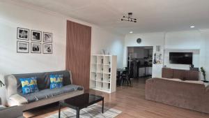 a living room with a couch and a table at Dago Family Stay in Bandung +4 photos