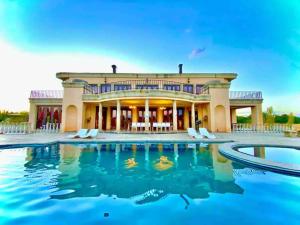 an exterior view of a large house with a swimming pool at Vaal-Villa, Vintage Style Farmhouse, Vaal River in Vanderbijlpark