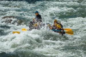 a group of people in a raft in a river at Departamentos Brown in San Rafael
