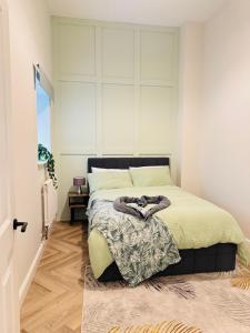 a bedroom with a bed with a large headboard at Grande View 8 in Eastbourne