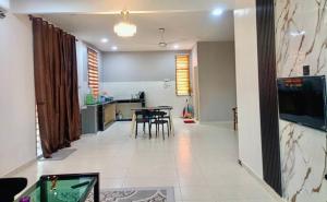 a dining room and kitchen with a table and chairs at Homestay harmonis kuantan in Kuantan +1 photo