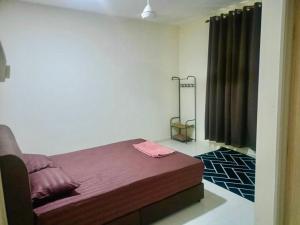 a bedroom with a bed and a black curtain at Homestay harmonis kuantan in Kuantan