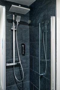 a shower with a shower head in a bathroom at Lit 3 en 1ère Classe-Orly-T7-RER C&D in Athis-Mons