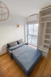 a bedroom with a bed and a book shelf at Check and Home - Colon IV - 4 Huéspedes Remodelado Zona Güemes in Mar del Plata
