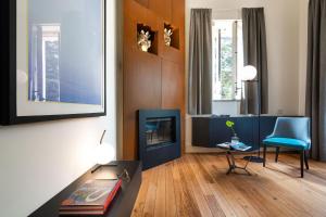 a living room with a fireplace and a blue chair at Villa Lime in Nunziata