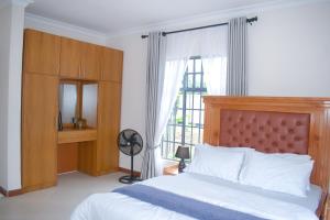 a bedroom with a bed and a large window at Luxury Peace House in Arusha