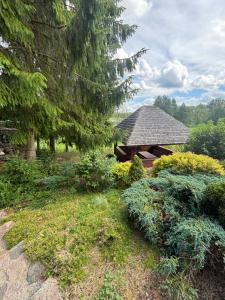 a gazebo in the middle of a garden at Sielanka Potopy in Potopy