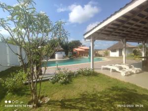 a view of a swimming pool with a pavilion at Studio au bord de la lagune in Assinie
