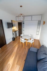 a living room with a couch and a table and chairs at Check and Home - Colon IV - 4 Huéspedes Remodelado Zona Güemes in Mar del Plata