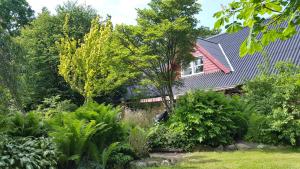 a house with a garden in front of it at Billund Farm Holiday in Billund