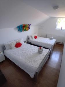 a bedroom with two beds and a couch at Camere de închiriat Trandafirilor  +20 photos