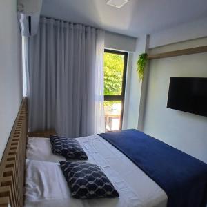 Ένα ή περισσότερα κρεβάτια σε δωμάτιο στο Acolhedor Flat em Tamandaré +14 φωτογραφίες