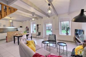 a living room with a couch and a table at La balancoire in Saint-Jean-Kerdaniel