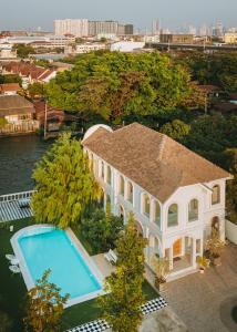an overhead view of a house with a swimming pool at Arpo Pool Villa Riverside Bangkok in Bangkok