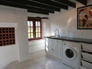 a laundry room with a washing machine and a window at Luxury rural farmhouse retreat in Yvrandes