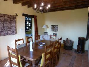 a dining room with a wooden table and chairs at Luxury rural farmhouse retreat in Yvrandes