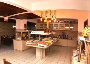 a kitchen with a table with food on it at Baleia Franca e Apart HS in Florianópolis