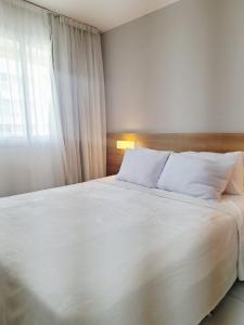 Postel nebo postele na pokoji v ubytování Suíte Confortável no Rio2 - Barra Olímpica RJ + 9 fotografií