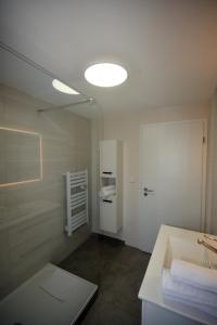 a bathroom with a sink and a mirror at LUNAR, proche frontière Basel, Free parking in Saint-Louis +9 photos