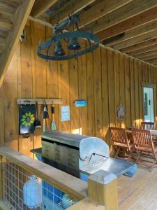 a kitchen with a stove and chairs in a cabin at Beech Creek Cabin, lower unit, Black Mountain in Black Mountain