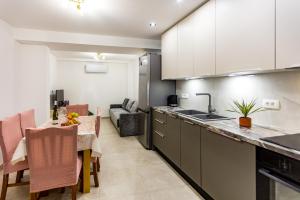 a kitchen with a table and a dining room at Kuća Ružica in Omiš